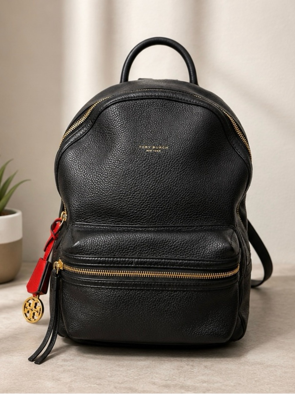 Tory Burch Black Leather Mini Backpack with Gold Accents and Red Charm